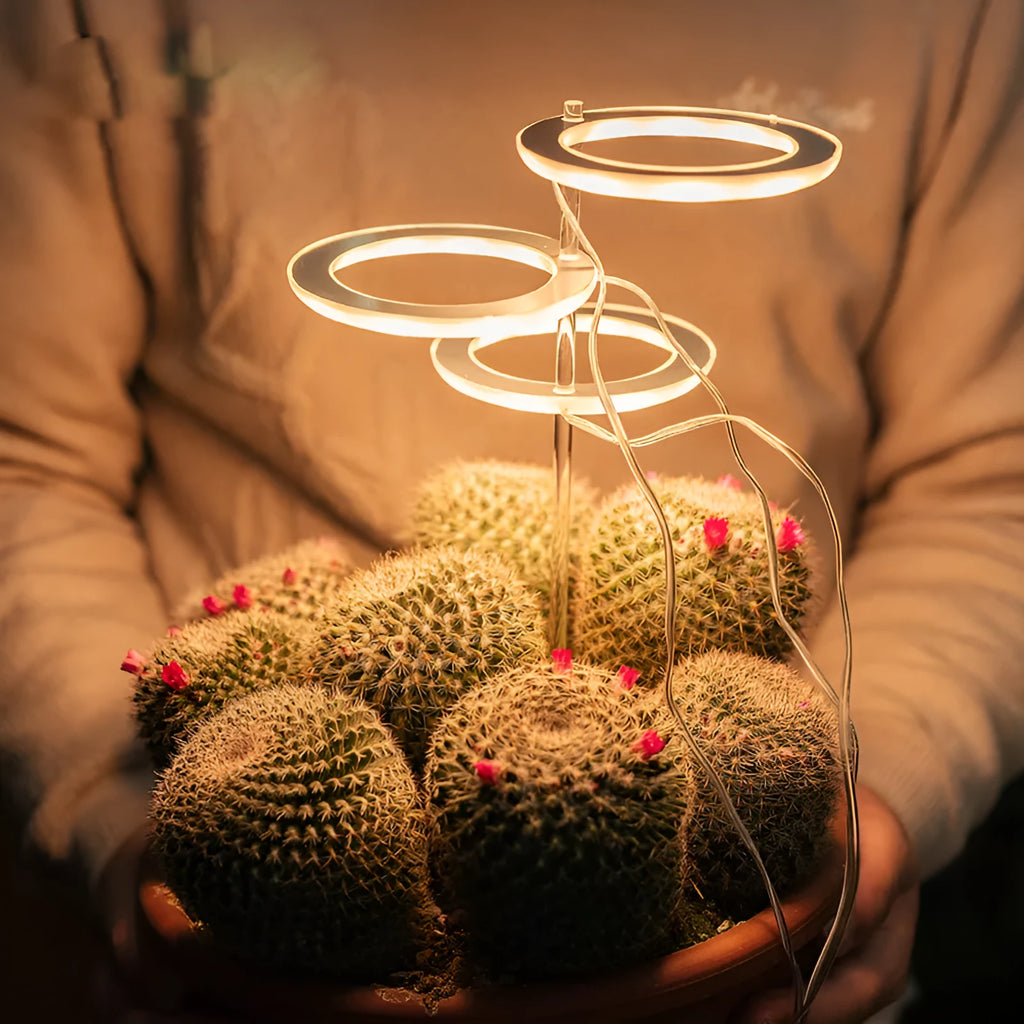 USB-powered full spectrum LED plant grow light with acrylic stick, shown in yellow light.