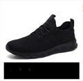 Men's black and white mesh sneakers with lace-up closure and round toe design