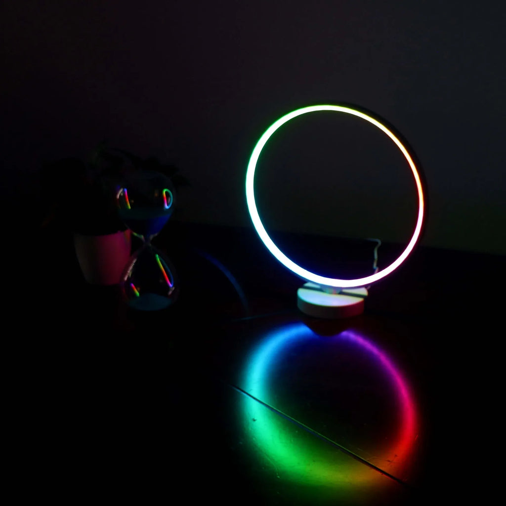 White aluminium and silicone full moon mood table lamp with remote control on wooden surface