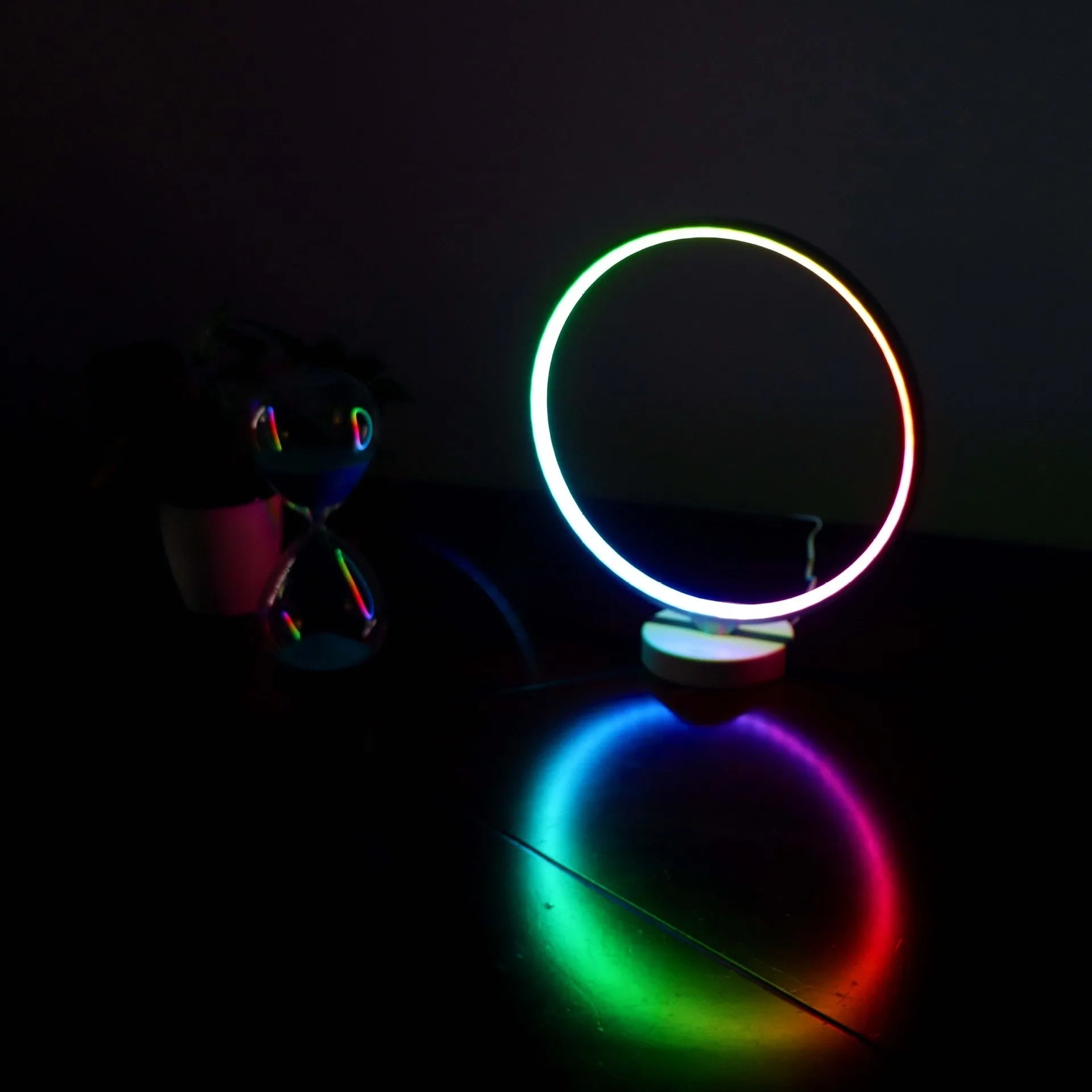 White aluminium and silicone full moon mood table lamp with remote control on wooden surface