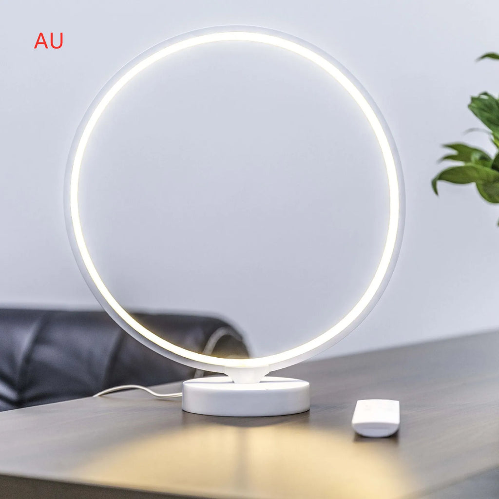 White aluminium and silicone full moon mood table lamp with remote control on wooden surface