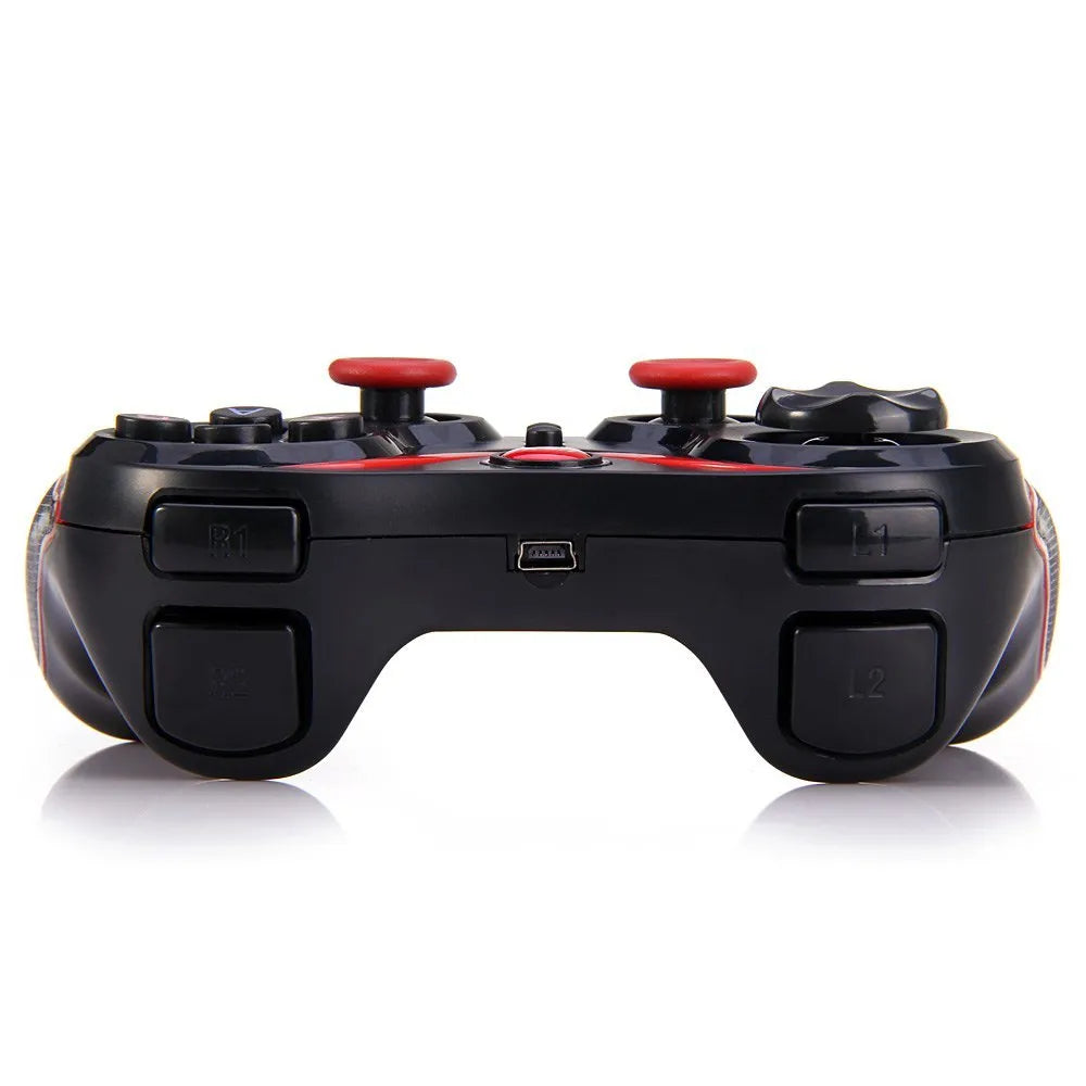 Black wireless Bluetooth gamepad controller for mobile phones on a table.