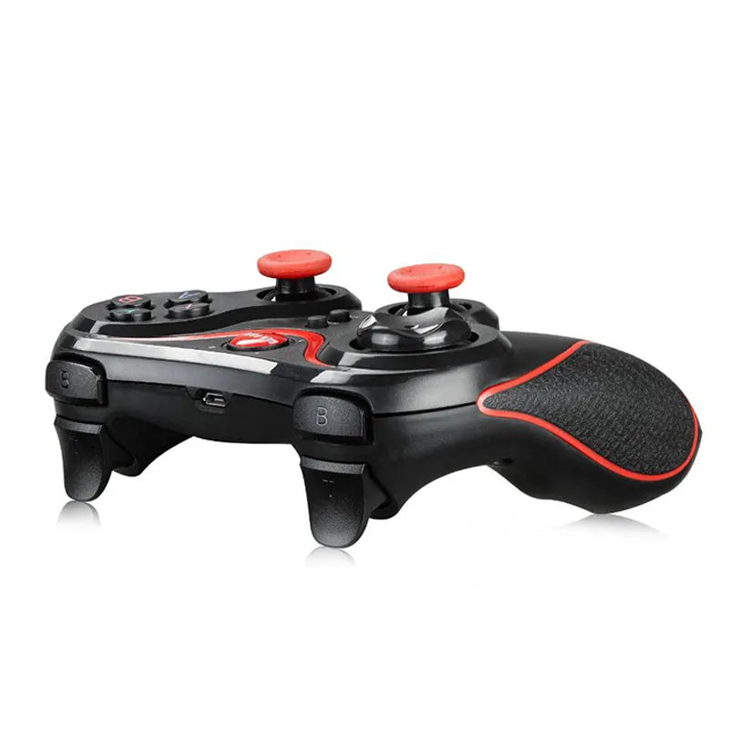 Black wireless Bluetooth gamepad controller for mobile phones on a table.