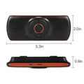 Orange plastic Bluetooth hands-free speaker for car sun visor mounting.
