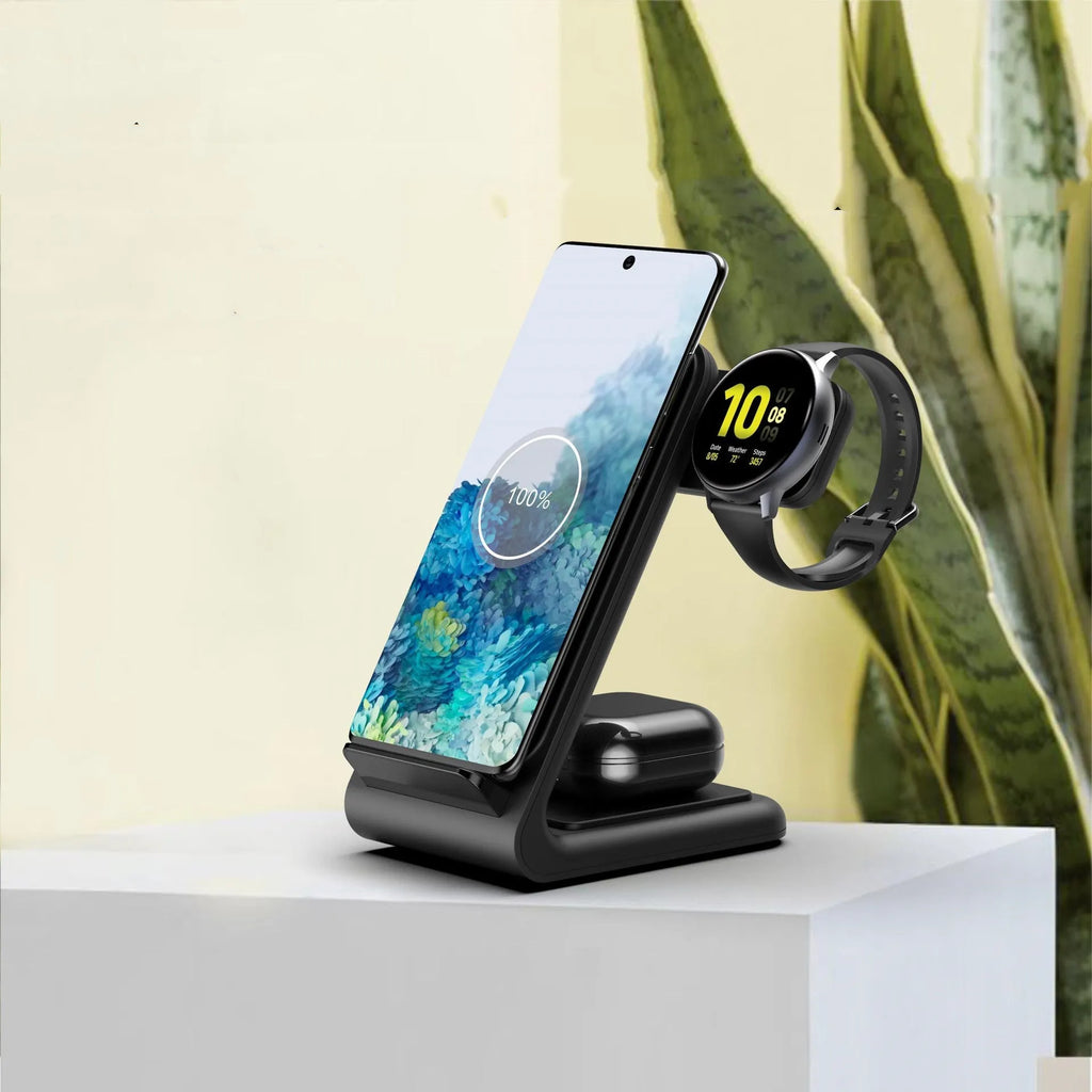 Black three-in-one wireless charging stand holding a mobile phone, an Apple Watch, and wireless earbuds.