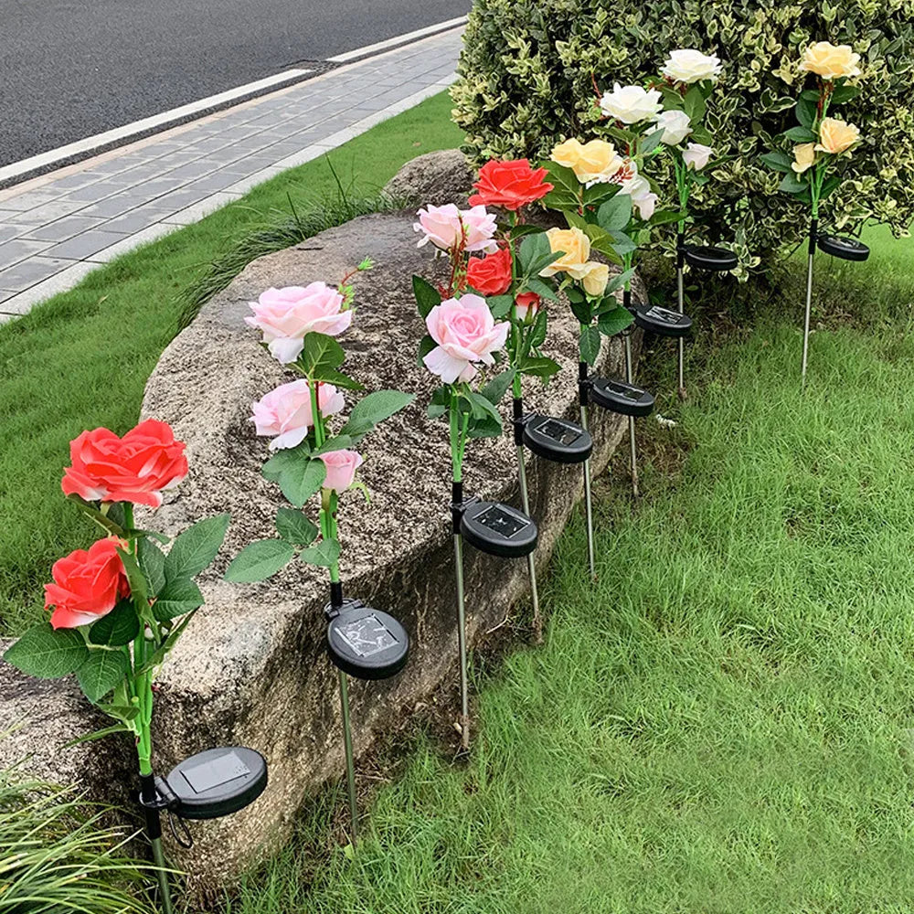 Solar rose garden lamp with three-head white LED lighting and ground spike for outdoor installation