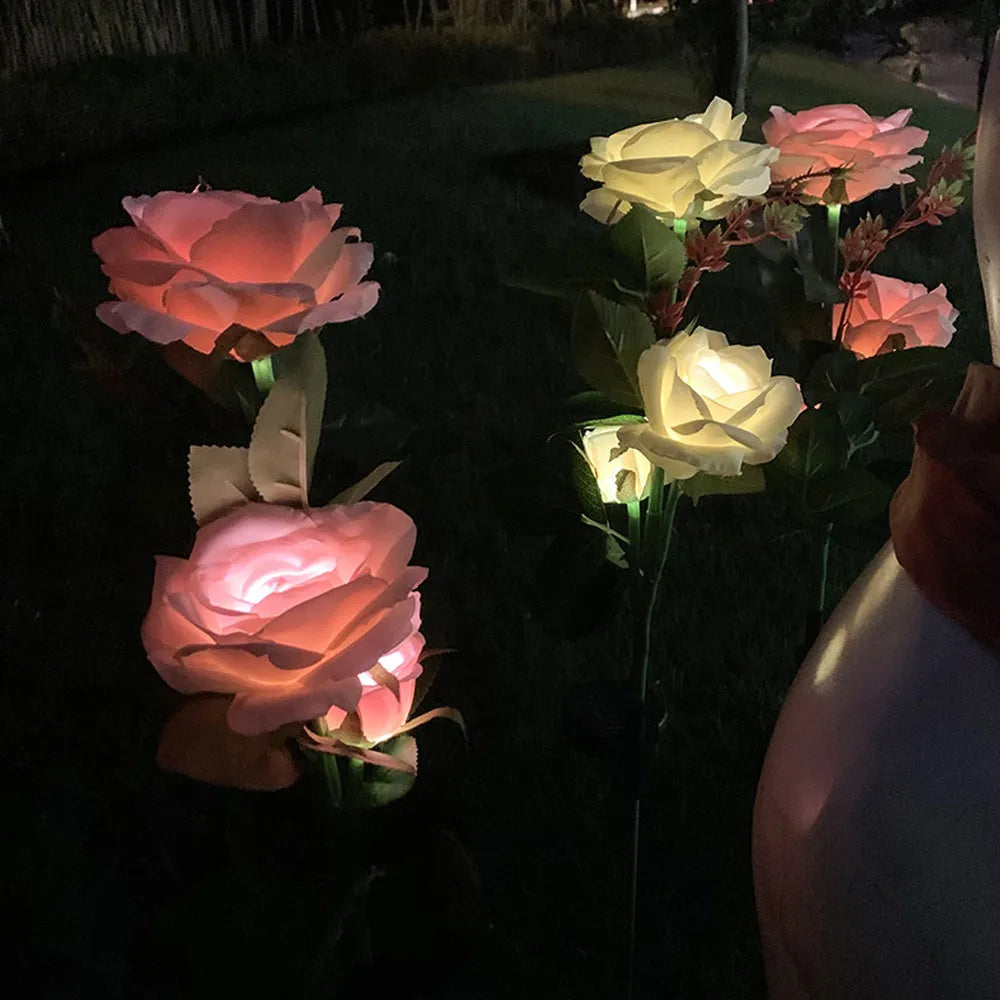 Solar rose garden lamp with three-head white LED lighting and ground spike for outdoor installation