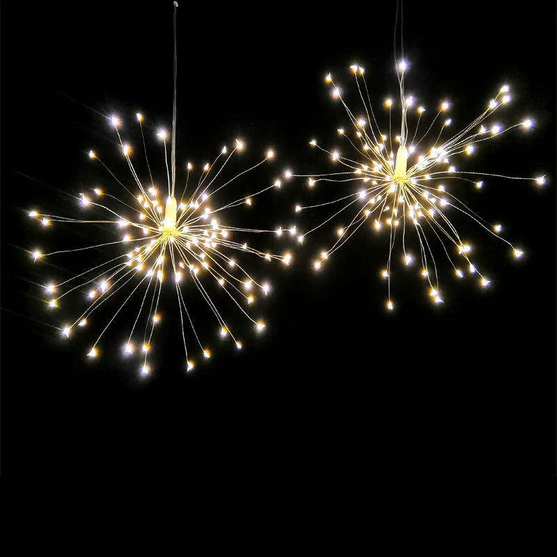 Solar-powered LED meteor shower light with multiple strands creating a warm white firework effect outdoors.