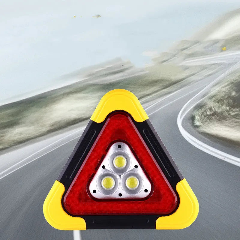 Solar reflective car warning triangle with COB LED light on a road at night