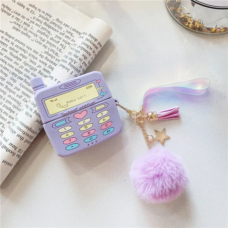 Purple silicone clamshell case for AirPods with fur ball pendant attached