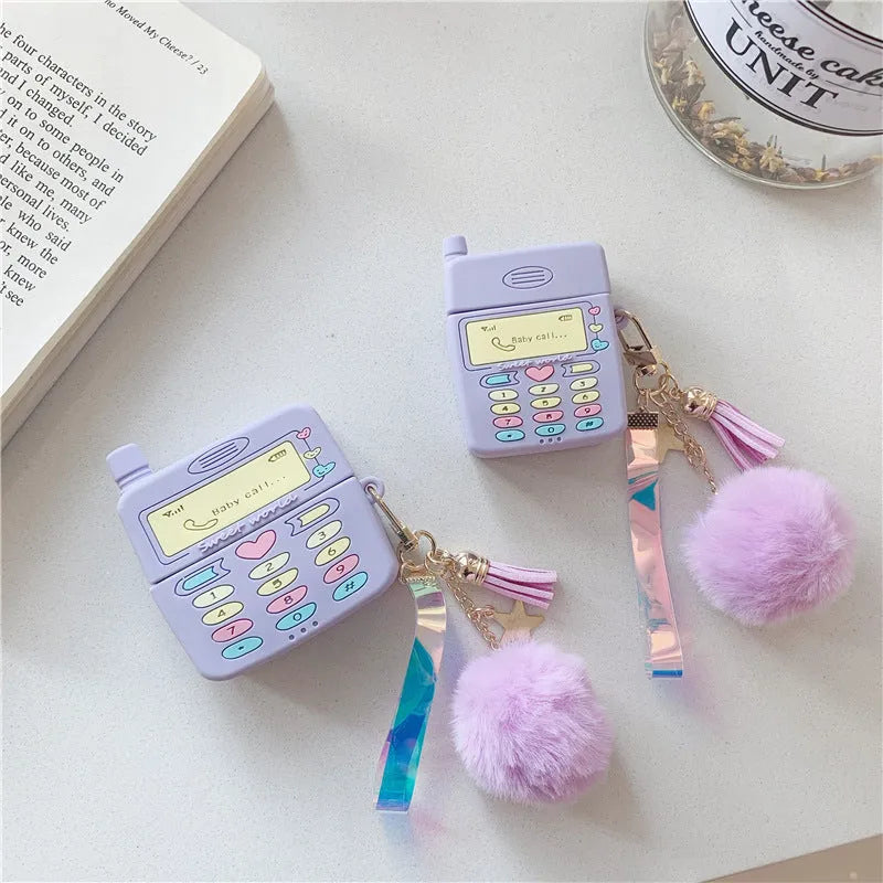 Purple silicone clamshell case for AirPods with fur ball pendant attached