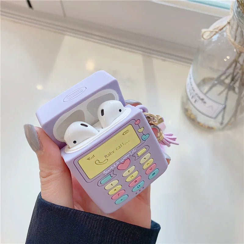Purple silicone clamshell case for AirPods with fur ball pendant attached
