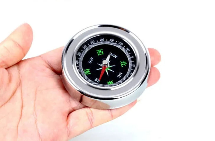Stainless steel handheld compass for hiking and camping with brushed metal finish, polished bottom, in white or yellow.