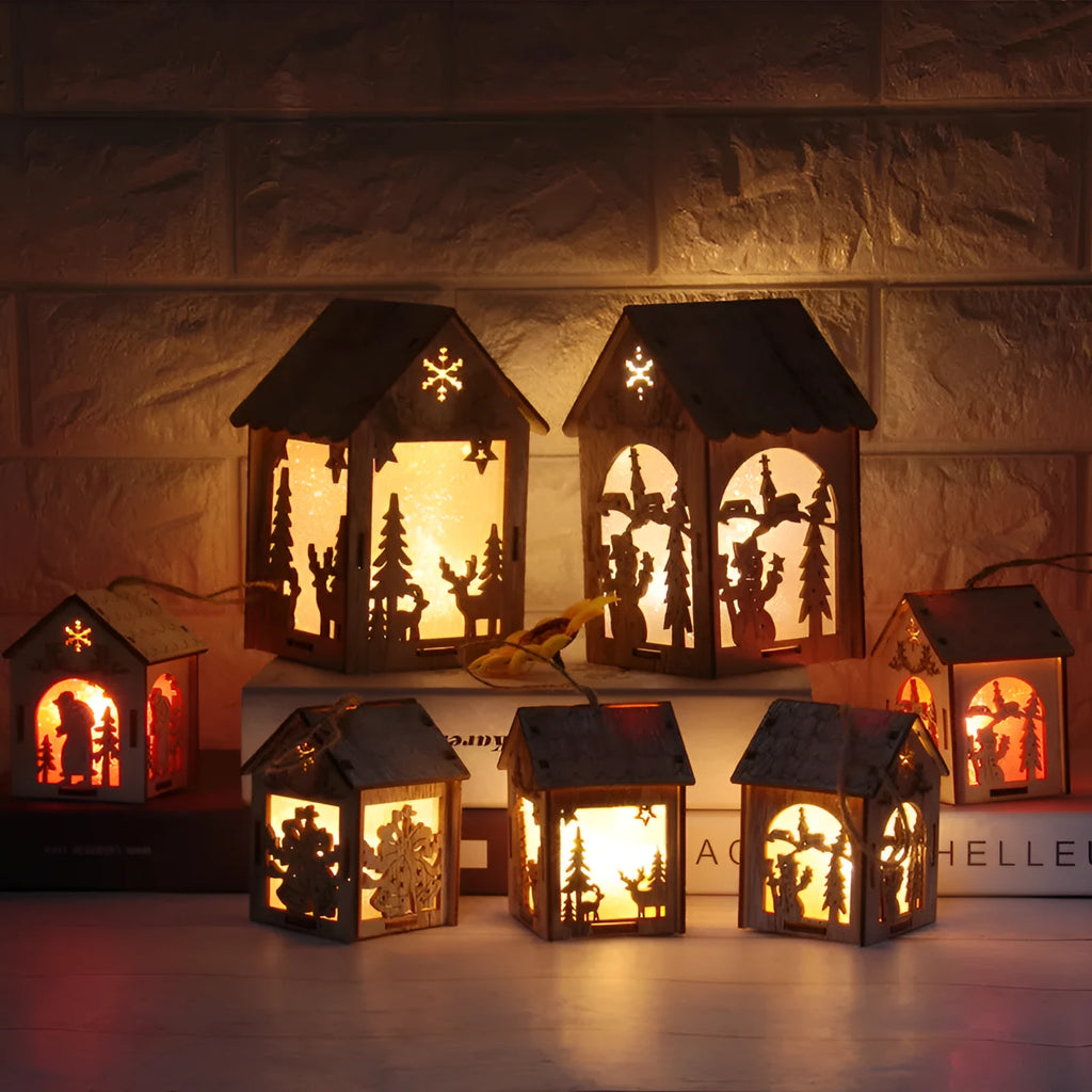 Three wooden Christmas house decorations including log bell, Santa house and snowman house in natural wood finish