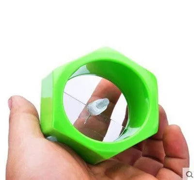 Yellow and green spiral vegetable cutter made from food-grade ABS plastic on a kitchen counter.