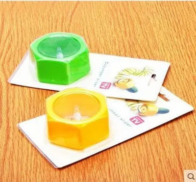 Yellow and green spiral vegetable cutter made from food-grade ABS plastic on a kitchen counter.