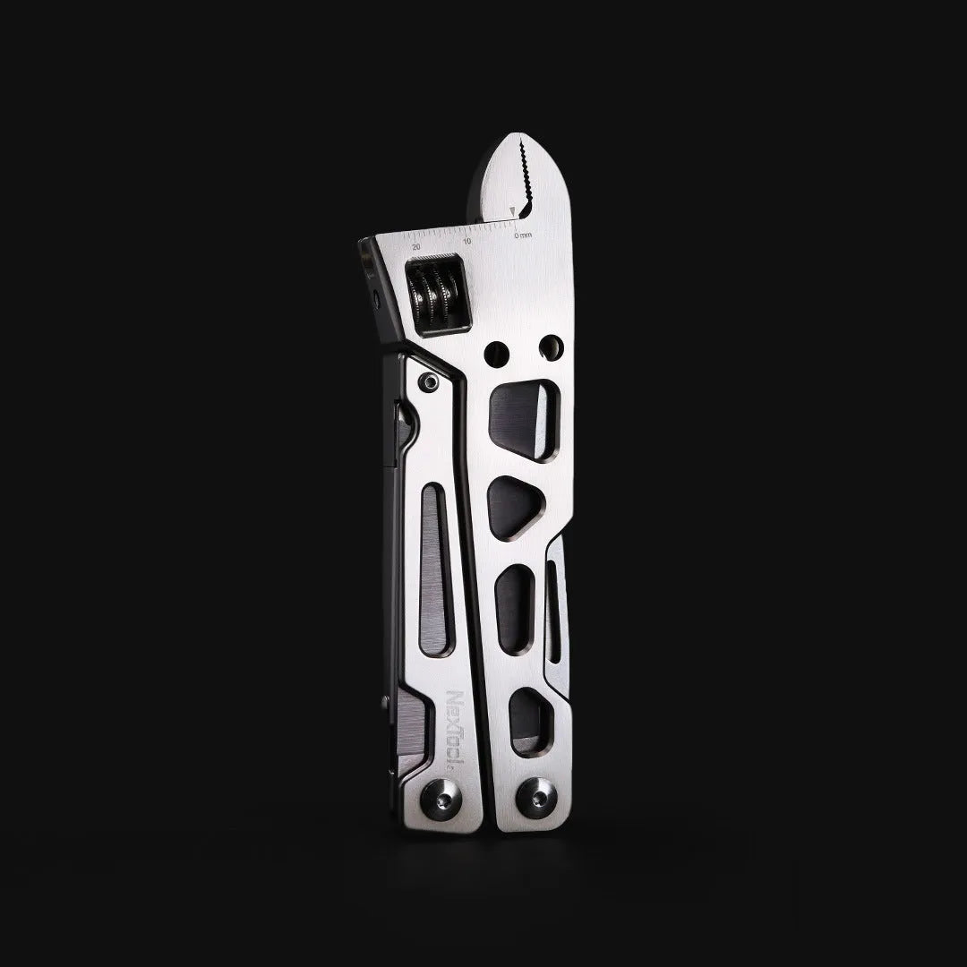 Stainless steel multi-function wrench tool with integrated knife and needle-nose pliers.