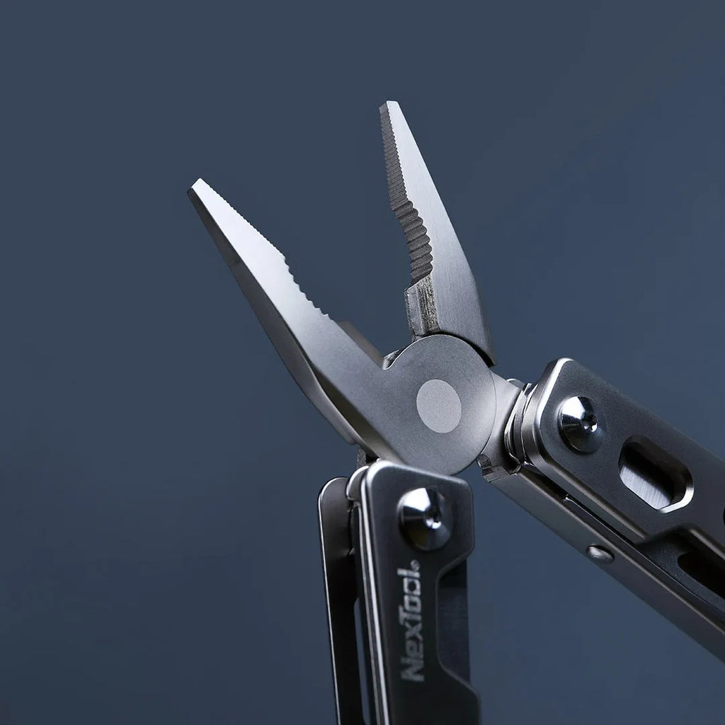 Stainless steel multi-function wrench tool with integrated knife and needle-nose pliers.