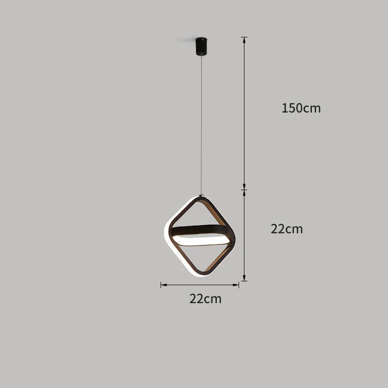 Black minimalist iron chandelier with remote control on a wooden bedside table.