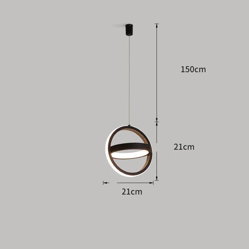 Black minimalist iron chandelier with remote control on a wooden bedside table.