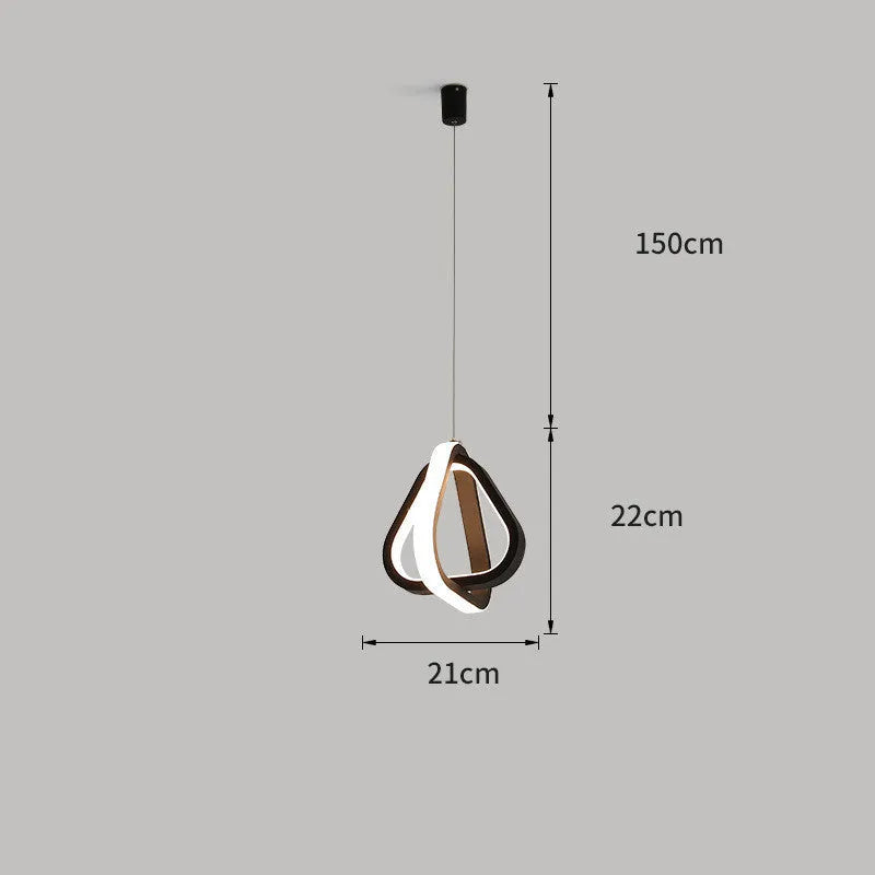 Black minimalist iron chandelier with remote control on a wooden bedside table.