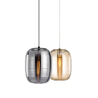Modern glass table lamp in cognac colour with a push-button switch on a wooden surface.