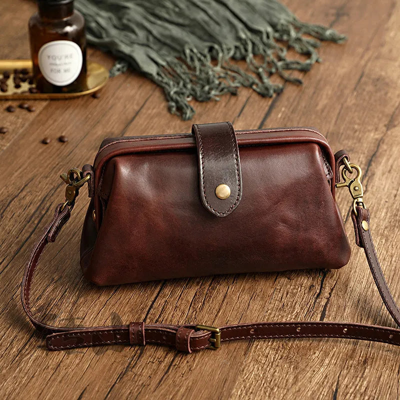 Clementine leather pillow-shape purse, 22cm x 12cm x 6cm, with single strap, cover closure, zip pocket, and phone bag.