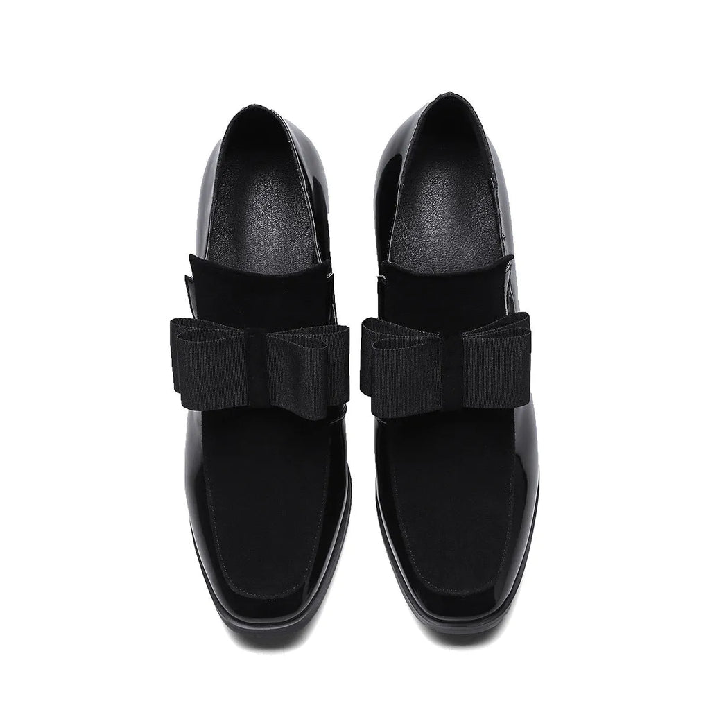 Black leather women's high heel shoes with a thick block heel and square toe, showing patent leather finish.