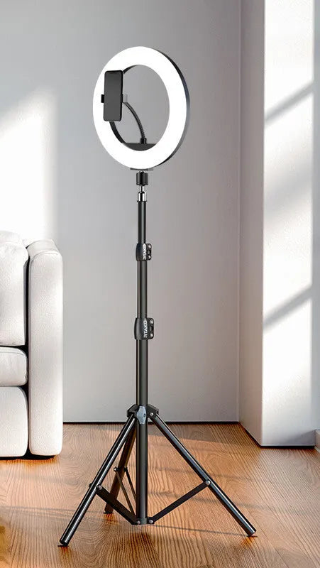 Carbon steel iPhone tripod stand with adjustable legs and a 10-inch ring light attached, next to its storage bag.