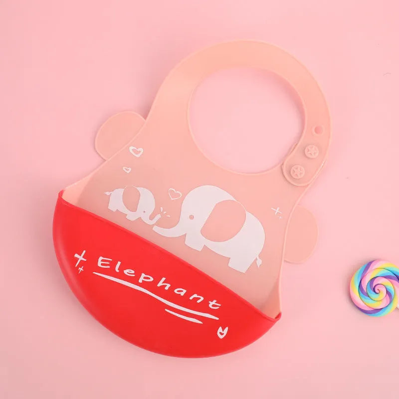 Waterproof silicone baby bib with food catcher pocket and adjustable neck in cartoon print.