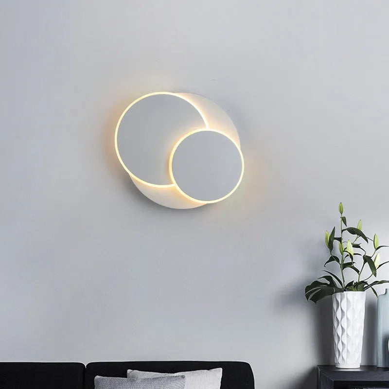 Modern round wall lamp with acrylic shade in black or white finish