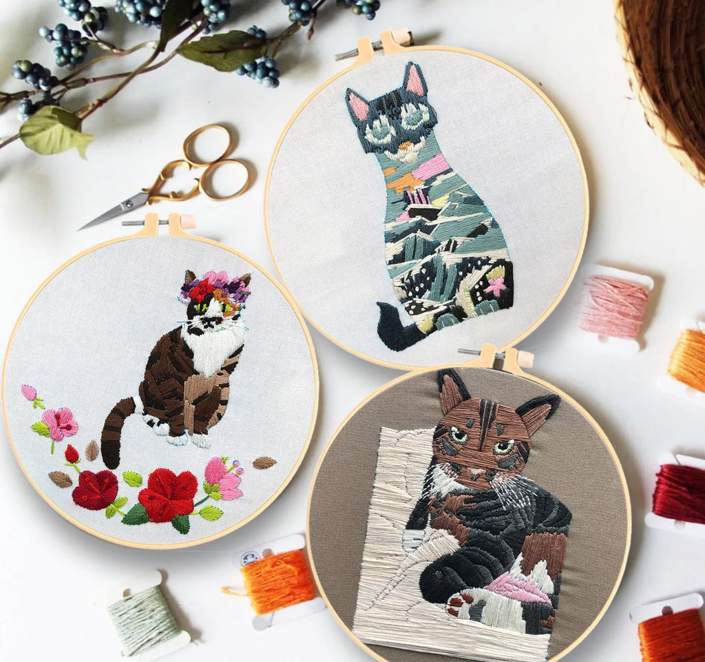 European embroidery starter kit showing pre-printed cat cross stitch design on fabric in a 15cm wooden hoop.