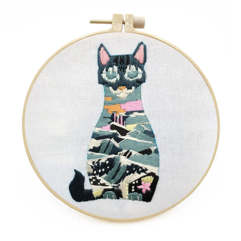 European embroidery starter kit showing pre-printed cat cross stitch design on fabric in a 15cm wooden hoop.