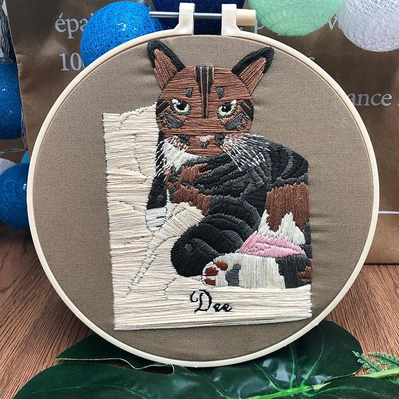 European embroidery starter kit showing pre-printed cat cross stitch design on fabric in a 15cm wooden hoop.