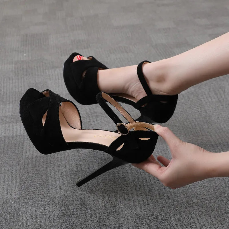 Black suede women's stiletto high heel sandals with fish mouth toe and Roman style platform.