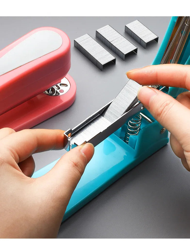 360-degree rotatable stapler in dark blue on a desk with A4 paper