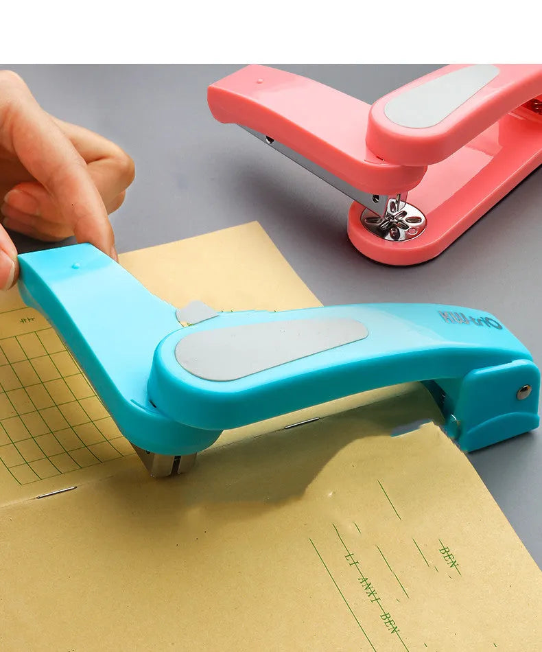 360-degree rotatable stapler in dark blue on a desk with A4 paper