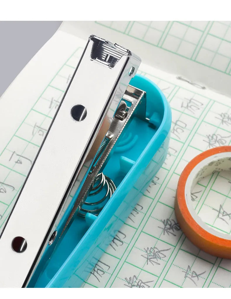 360-degree rotatable stapler in dark blue on a desk with A4 paper