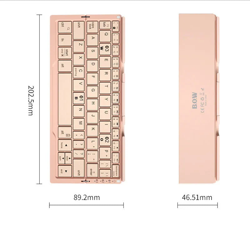 Silver white mini aluminium folding Bluetooth keyboard open next to a smartphone on its integrated stand.