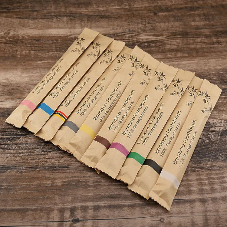 Set of 10 bamboo toothbrushes with charcoal bristles in assorted colours including white, yellow, purple, grey, green, and black