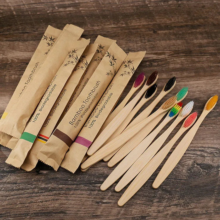 Set of 10 bamboo toothbrushes with charcoal bristles in assorted colours including white, yellow, purple, grey, green, and black