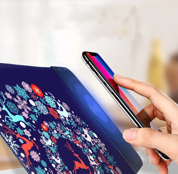 Cartoon wireless charging mouse pad with RGB lighting on black desk