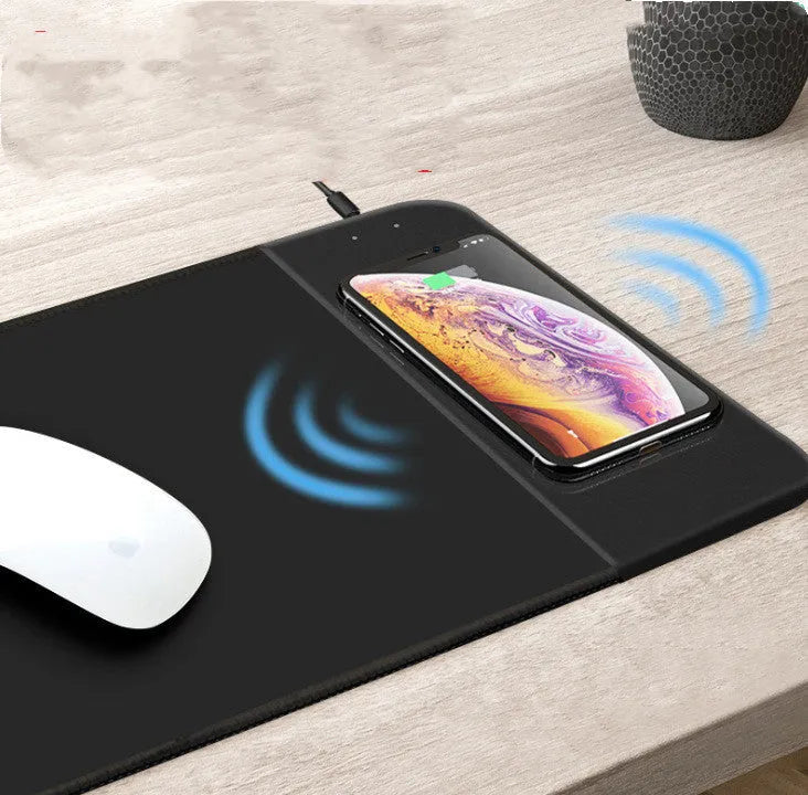 Cartoon wireless charging mouse pad with RGB lighting on black desk