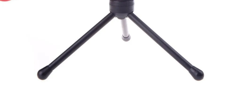 Black wired PC microphone with clothing clip attached, shown with separate desk bracket and long cable.