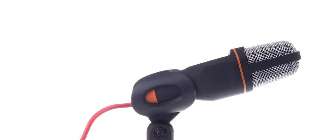 Black wired PC microphone with clothing clip attached, shown with separate desk bracket and long cable.