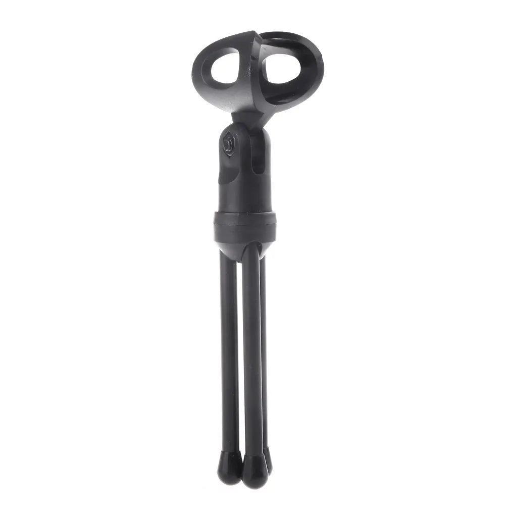 Black wired PC microphone with clothing clip attached, shown with separate desk bracket and long cable.