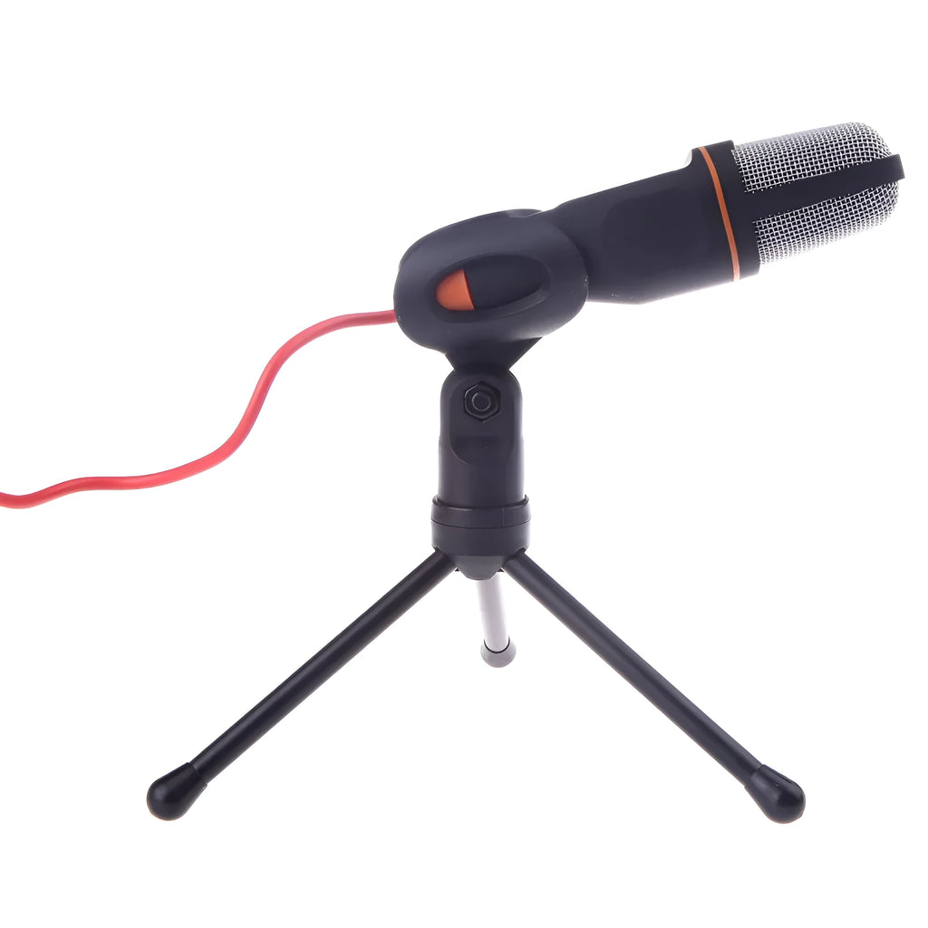Black wired PC microphone with clothing clip attached, shown with separate desk bracket and long cable.