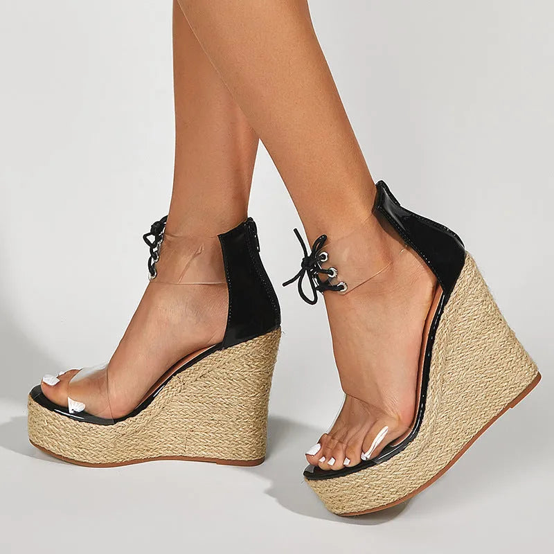Black women's wedge sandals with hemp rope detail, high wedge heel, and front tie closure.