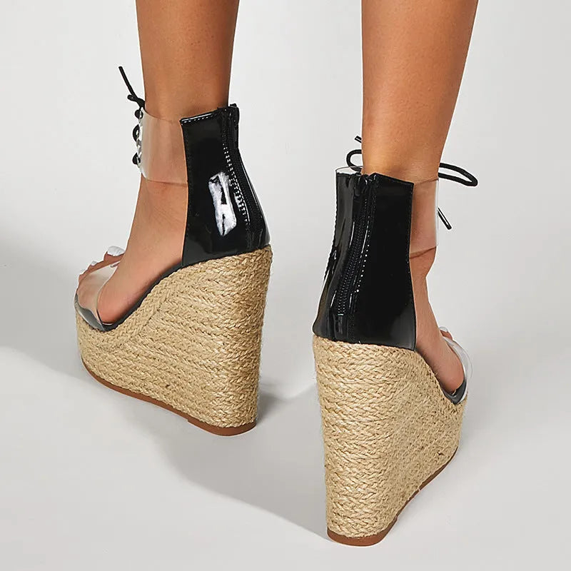 Black women's wedge sandals with hemp rope detail, high wedge heel, and front tie closure.