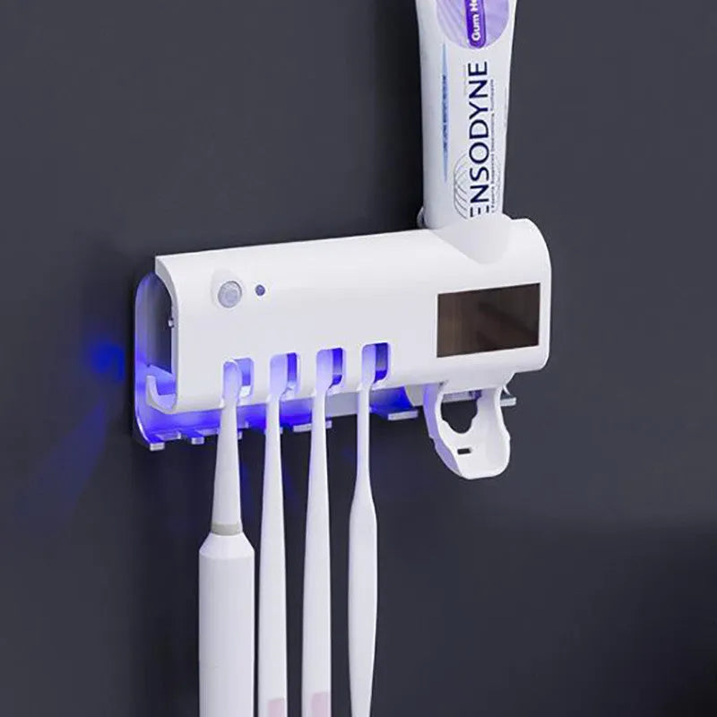 Wall-mounted UV toothbrush steriliser with automatic toothpaste squeezer and solar panel